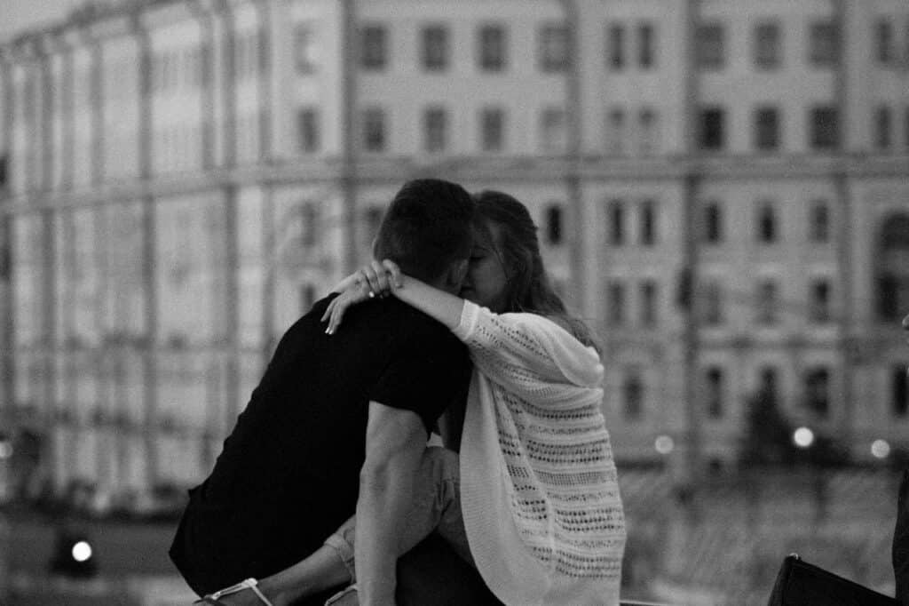 A couple embracing in a black-and-white city scene